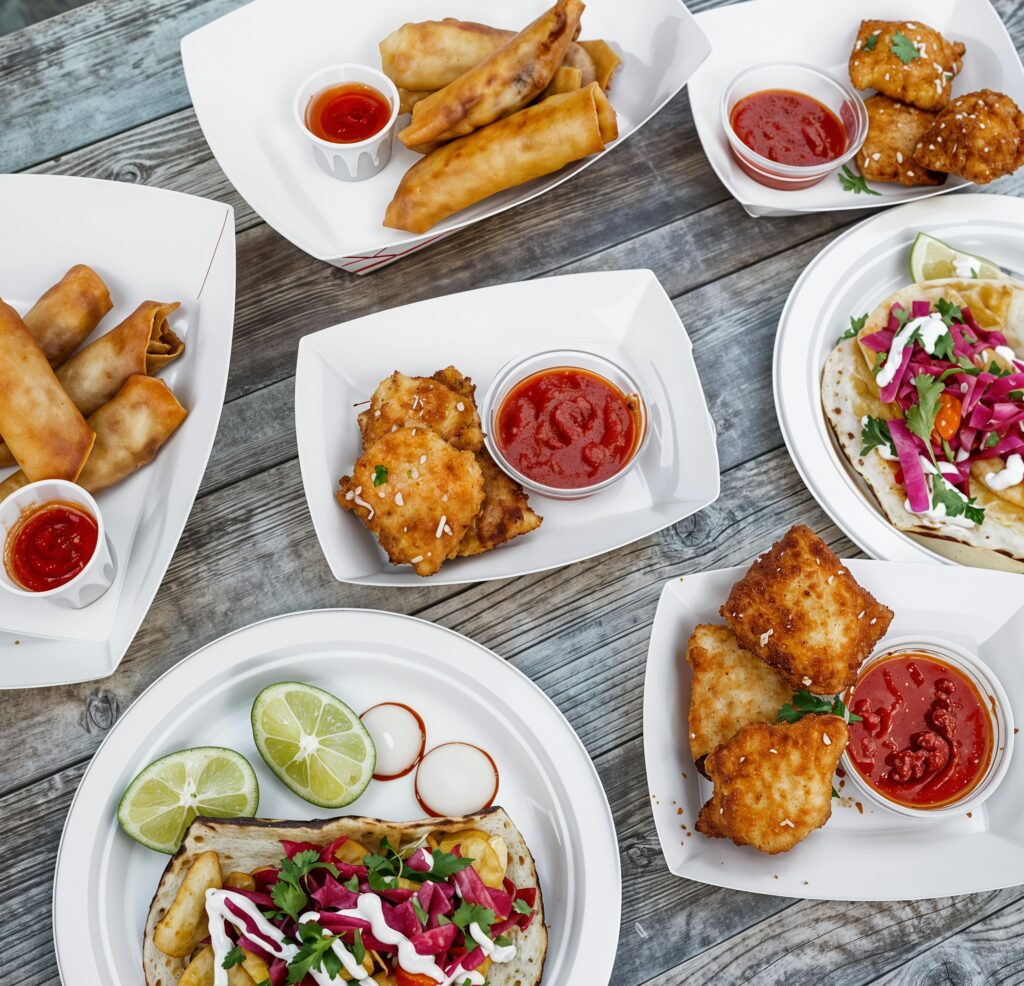 Explore a vibrant selection of street food dishes featuring tacos, spring rolls, and more, beautifully presented.